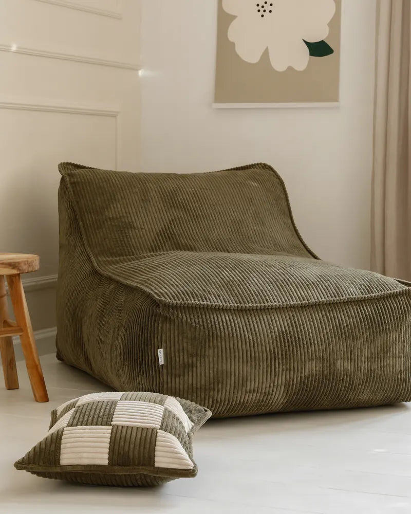Kumo Lounger w kolorze Dusty Sage, widok z przodu pod kątem, w jasnym pokoju